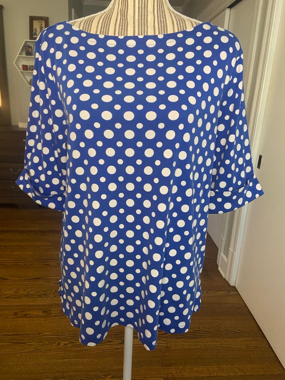 Kim Roger’s bright blue with white polka dots short sleeve ballet neckline top